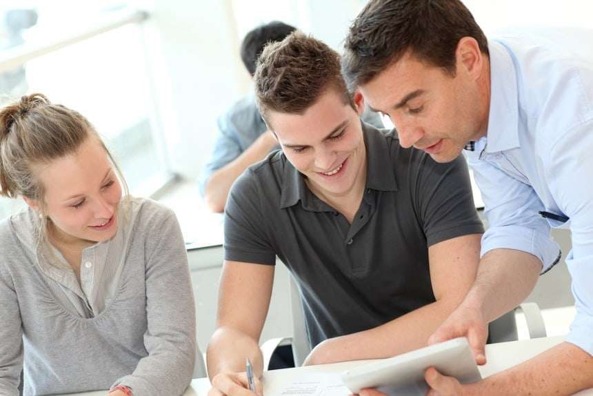 Teacher helping students with assignment Teacher helping students with assignment 1
