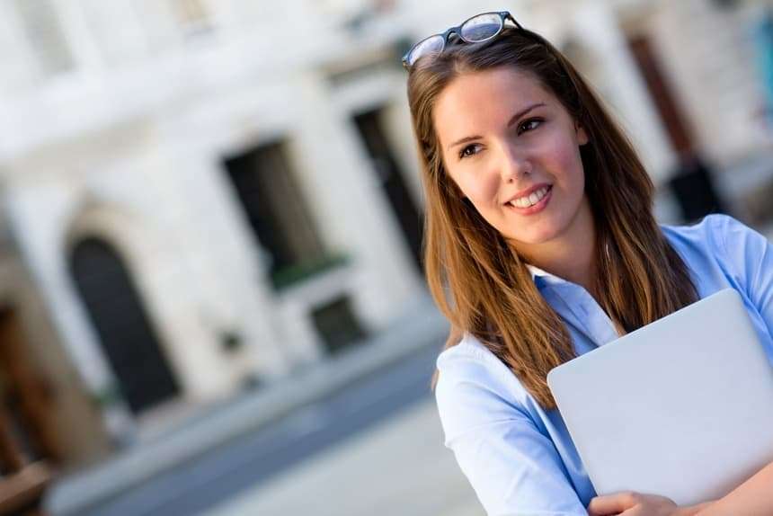 Young business woman holding a laptop computer Young business woman holding a laptop computer