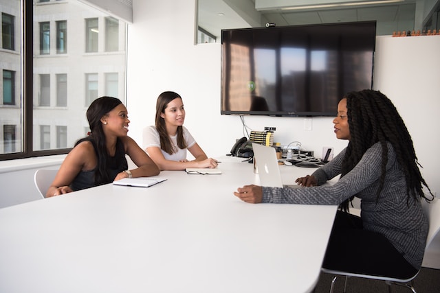 Job searching young graduates around a table